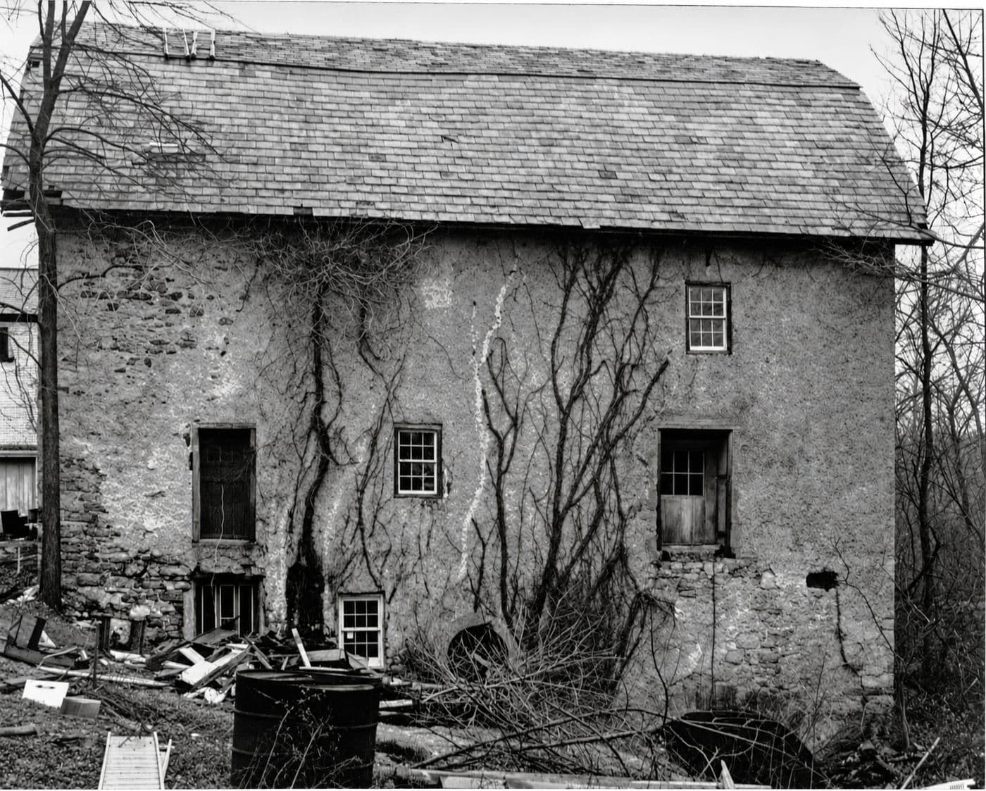 The same pre-restoration view of the plastered mill, contrast and detail recovered