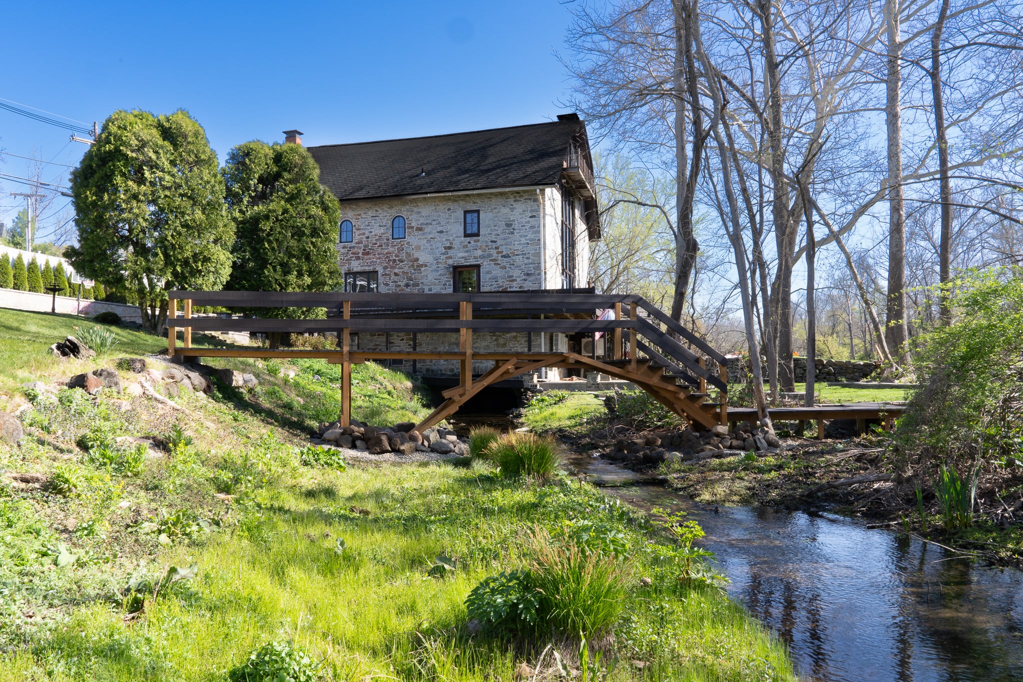 Beattystown Mill — 1762 stone mill with wooden bridge over the stream